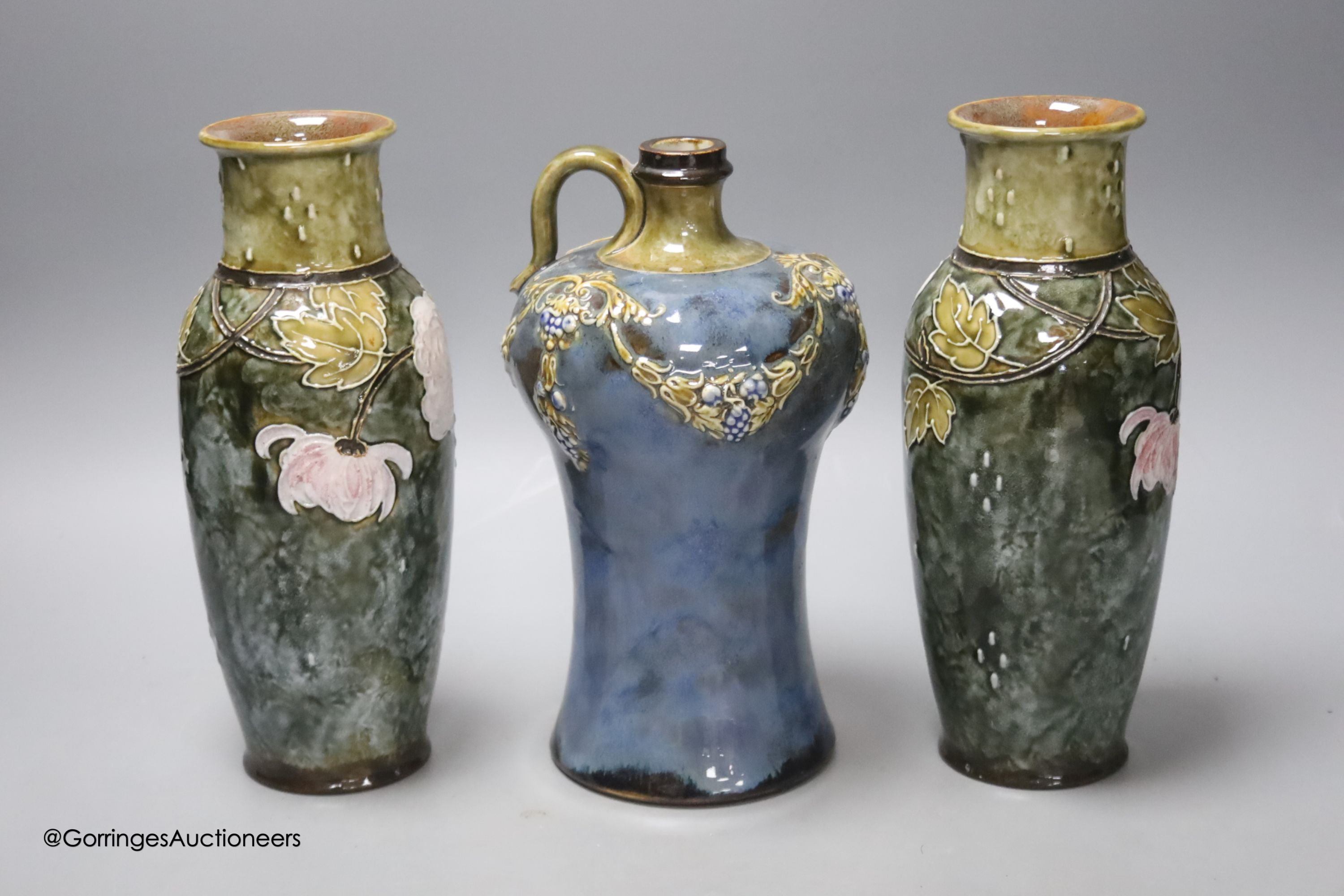 A pair of Doulton vases, 23cm high, together with a Doulton flask, 22cm high (3)